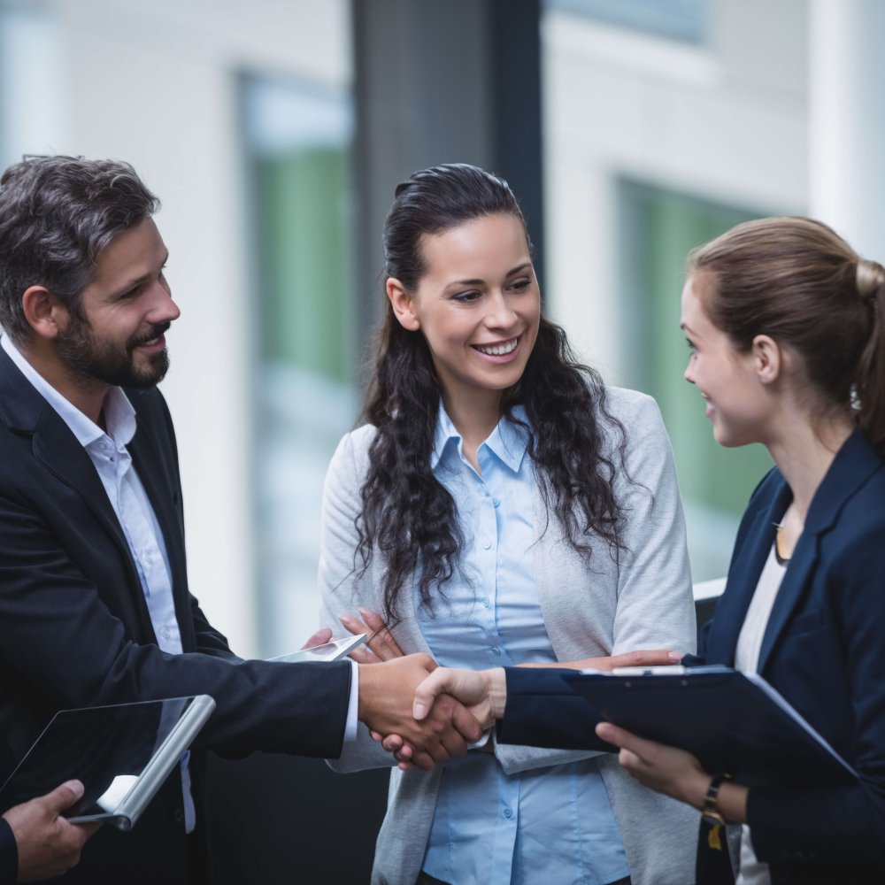 Group of businesspeople having a discussion near staircase in office